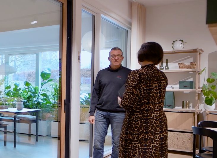 Professional installer discussing double glazing installation inside a UK home, showing the fitting and consultation process